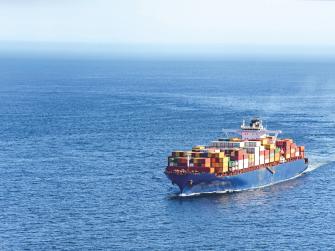 A shipping boat traveling through the ocean.