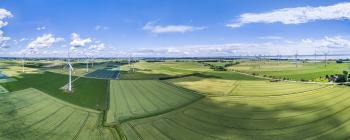 European countryside dotted with windmills on a mostly sunny day